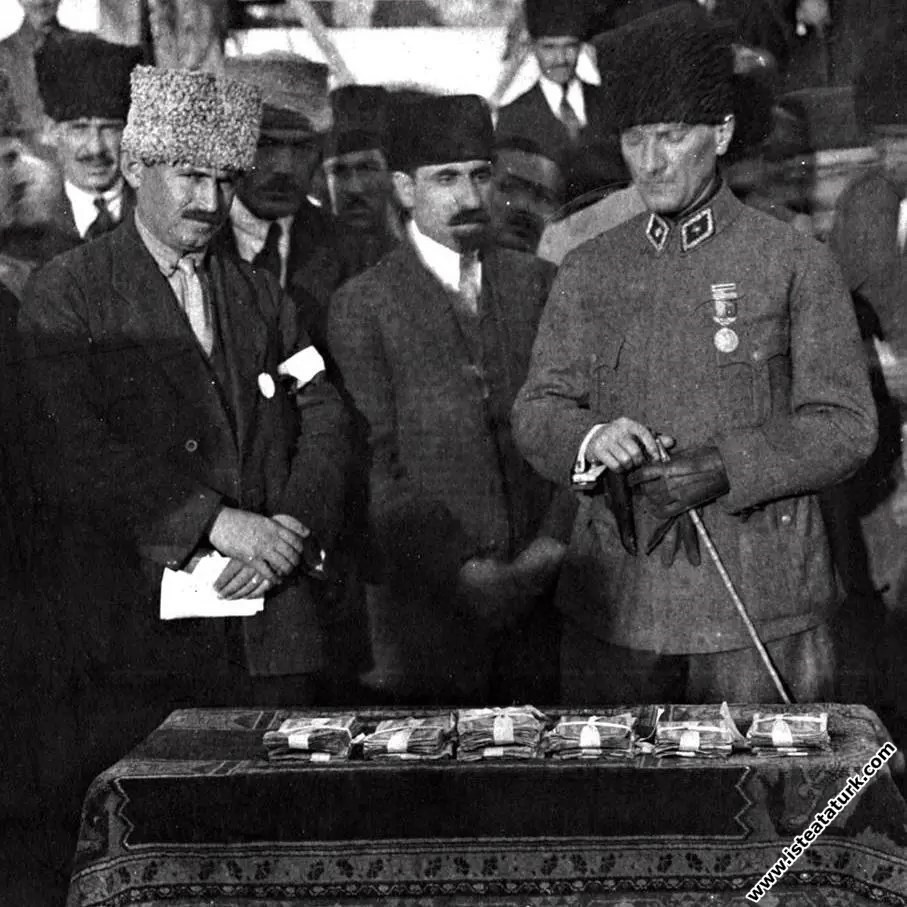 Mustafa Kemal Paşa Himaye-i Etfal Cemiyeti yararına Ankara Hipodromunda düzenlenen At yarışlarında yetimler için toplanan yardım paralarına nezaret ederken.  (11.11.1921